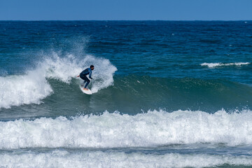 Surfer riding waves in Furadouro Beach