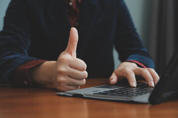 Asian Businesswoman Using laptop computer and working at office with calculator document on desk, doing planning analyzing the financial report, business plan investment, finance analysis concept.