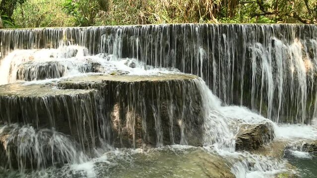 Tat Kuang Si Waterfalls is a limestone waterfall emerald green Inside the waterfall, there is an orderly tour arrangement. It is known as the most beautiful waterfall of Luang Prabang city in Laos.