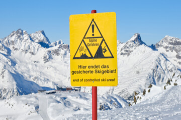 End of a ski area warning sign on ski slope, in German, at Ischgl ski resort, on the border of...