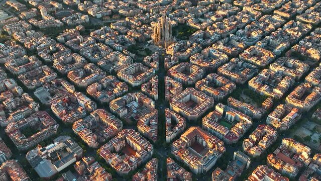 Aerial view of Barcelona Eixample residential district and famous Basilica Sagrada Familia at sunrise. Catalonia, Spain