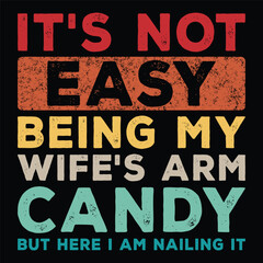 Fototapeta premium It's Not Easy Being My Wife's Arm Candy but Here I Am Nailing It t-shirt design.