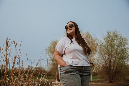 plus size woman wears sunglasses outside