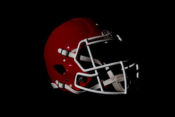 American red football helmet isolated on black background , product shot.
