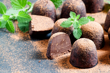 Homemade chocolate truffles with mint sprinkled with cocoa powder, selective focus