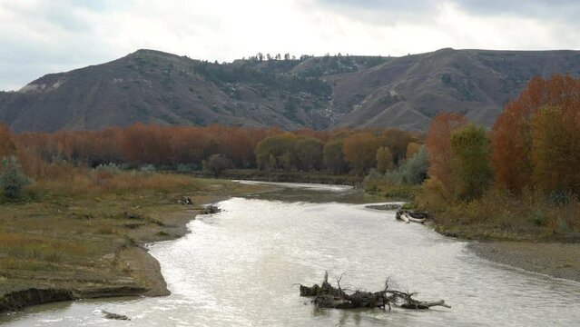 Looking upstream along Judith River towards snowy hills