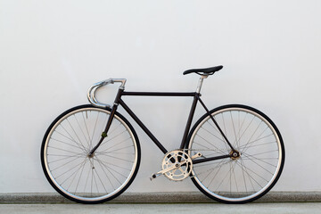 Fototapeta na wymiar City bicycle fixed gear and concrete wall