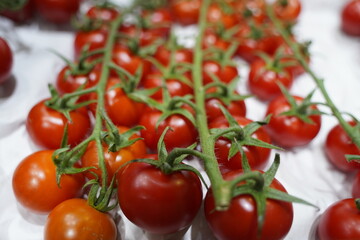 Fresh selected tomatoes in wooden boxes on sale.