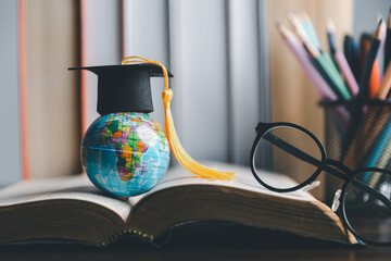 Graduation cap with Earth globe. Concept of global business study, abroad educational, Back to School. Education in Global world, Study abroad business in universities in worldwide. language study - obrazy, fototapety, plakaty