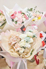 Flower shop concept. Different varieties fresh spring flowers in refrigerator room for flowers. Bouquets on shelf, florist business