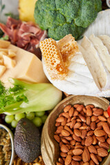 Brie cheese with honey close-up. Table full of mediterranean appetizers, tapas or antipasto. Assorted Italian food set. Delicious snack on party or picnic time. Italian style banquet. 