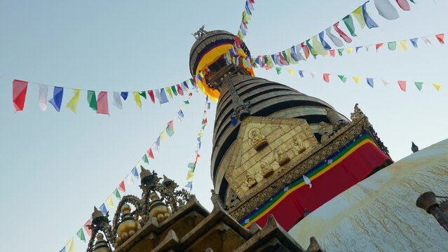 View from under Swayambhunath pagoda roof, ancient buddhist temple with prayer flags moving in the wind, in Kathmandu, Nepal