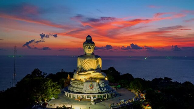 aerial Hyperlapse view around Phuket big Buddha in beautiful twilight..360 degree view at Phuket big Buddha..Video clips for travel and religious ideas..amazing red cloud in dark blue sky background