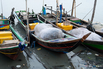 Rows of fishing net boats parked at a fish auction in Indonesia