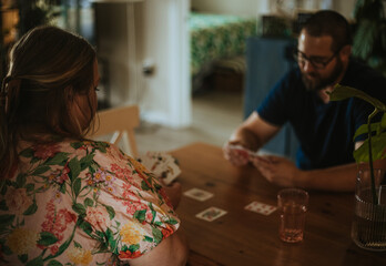 couple plays cards at table