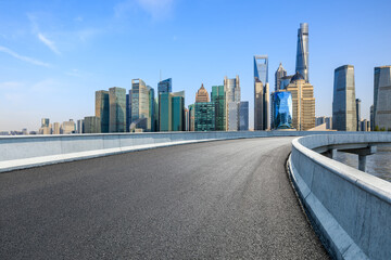 Asphalt road and city skyline with modern buildings in Shanghai, China.