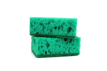 Two green sponges for washing dishes lie on a white background.	