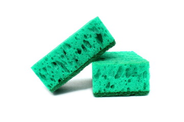 Two green sponges for washing dishes lie on a white background.	