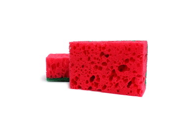Two red sponges for washing dishes lie on a white background.