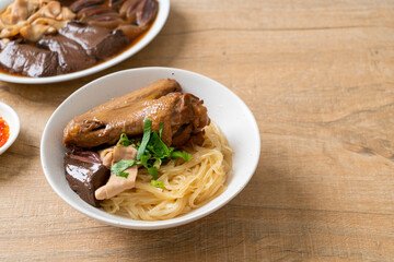dried noodles with braised duck in white bowl