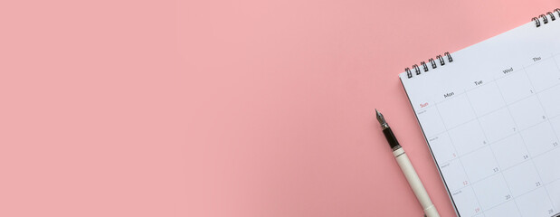 Concept of plan a monthly calendar for meetings or manage your daily activities.Pink banner. Copy space. © MohamadFaizal