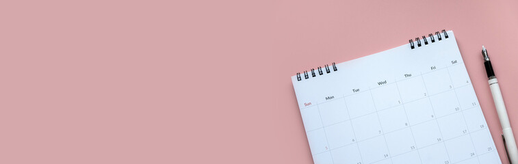 Concept of plan a monthly calendar for meetings or manage your daily activities.Pink banner. Copy space.