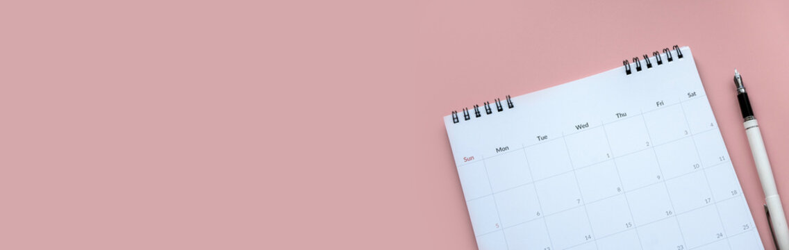Concept of plan a monthly calendar for meetings or manage your daily activities.Pink banner. Copy space.