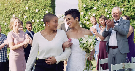 Wedding, happiness and interracial lesbian couple walking down aisle with smile, love and applause....