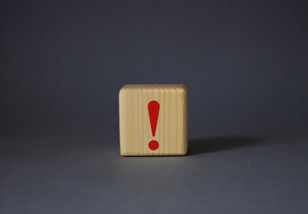 Exclamation mark symbol. Exclamation mark on wooden cubes. Beautiful grey background. Business and...