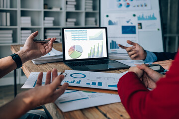 Two business people meeting to talking or discuss marketing work in workplace using paperwork, calculator, computer to work