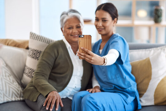 Caregiver, phone selfie or old woman in nursing home with smile or happiness for profile pictures or retirement. Women, mobile photography or happy nurse smiling with elderly patient for wellness