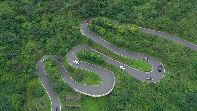 TAIWAN, TAROKO - MAY, 2023: Winding Road with Transport Traffic among Green Lush Forest Trees in Taroko Gorge National Park in Taiwan. Aerial Top View