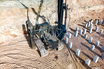 Pile driving machine. Diesel hammer pile driving machine working on construction site. Preparation of the pile foundation for the construction of the building.