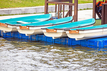 Fototapeta premium Pleasure rowing boats lie on the pier on a spring day
