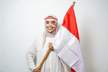 Portrait of Young Asian Muslim Women celebrate Indonesian independence day holding red and white...