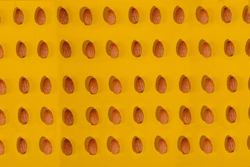 Almonds seed isolated on yellow background