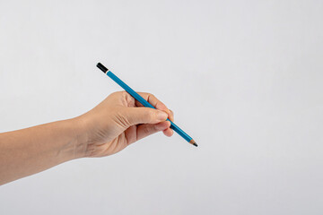 Close-up of a woman's hand holding a pen and writing gesture isolated on a white background