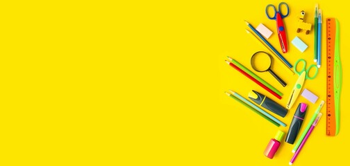 Banner on yellow background flat mockup of stationery for school, colored pencils, felt-tip pens, ruler, eraser, scissors.  Back to school concept.  Space for copy text.