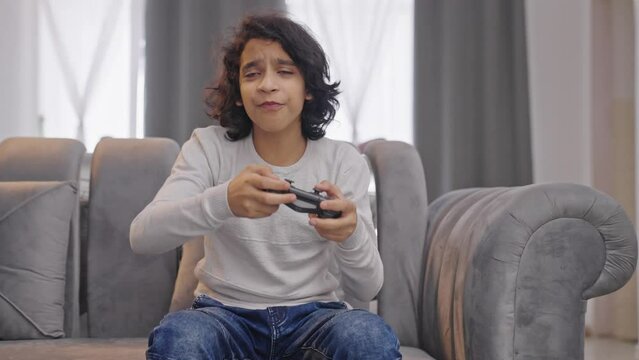 Indian kid boy playing video games