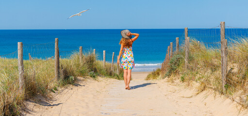 Woman walking to the beach- atlantic ocean in France © M.studio