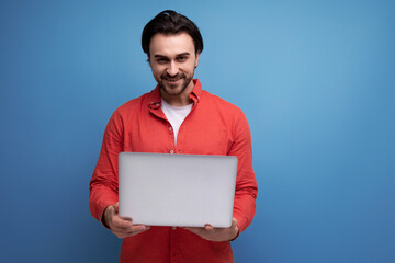 european dark haired 35 year old male freelancer with laptop over isolated background with copy...