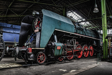 Plakat steam locomotives rest in the silence of the depot
