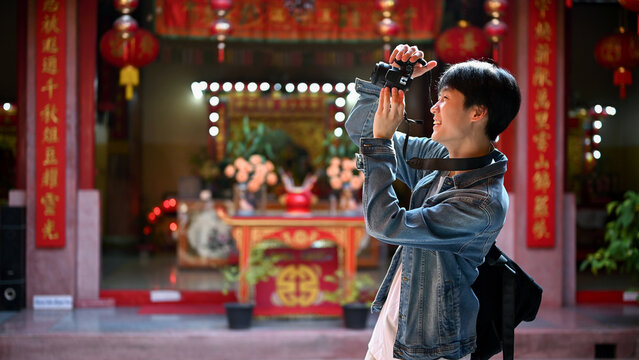 A Male Traveler Is Enjoying His Solo Travel Trip In Thailand And Taking Photos In A Chinese Temple.