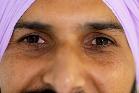 Portrait of happy sikh male doctor in turban looking at camera and smiling