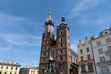 Fototapeta na wymiar St. Mary's Basilica at the Main Market Square in the Old Town district of Krakow, Poland. Bazylika Mariacka Kraków, Kościół Mariacki church in Cracow.