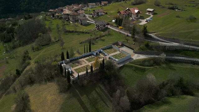 Aerial circling view of San Lorenzo in Banale graveyard in province of Trento of Trentino Alto Adige, Italy