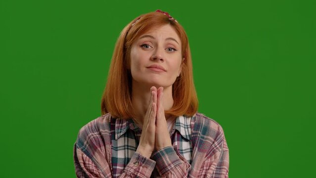 Joined hands pleading for help and support or woman praying for God over green screen background. Calm female asking for help. Body language conept.
