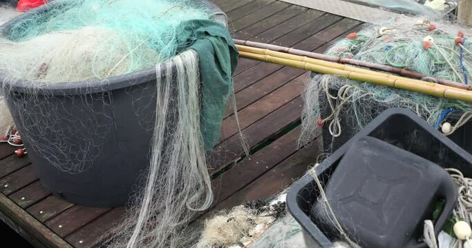 Fishing rods and fishing nets on the pier in the port of Piran, Slovenia.