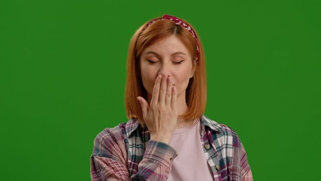 Portrait of woman hide her mouth with hand on green screen background. I will not say anyone. Frightened woman closing mouth with hands, looking intimidated scared at camera, gesture.