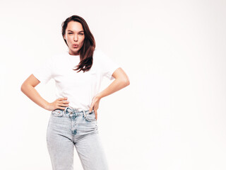 Obraz premium Young beautiful woman. Trendy carefree model in casual summer white T-shirt and blue jeans. Positive female isolated on white in studio. Cheerful and happy. Copy space, mockup
